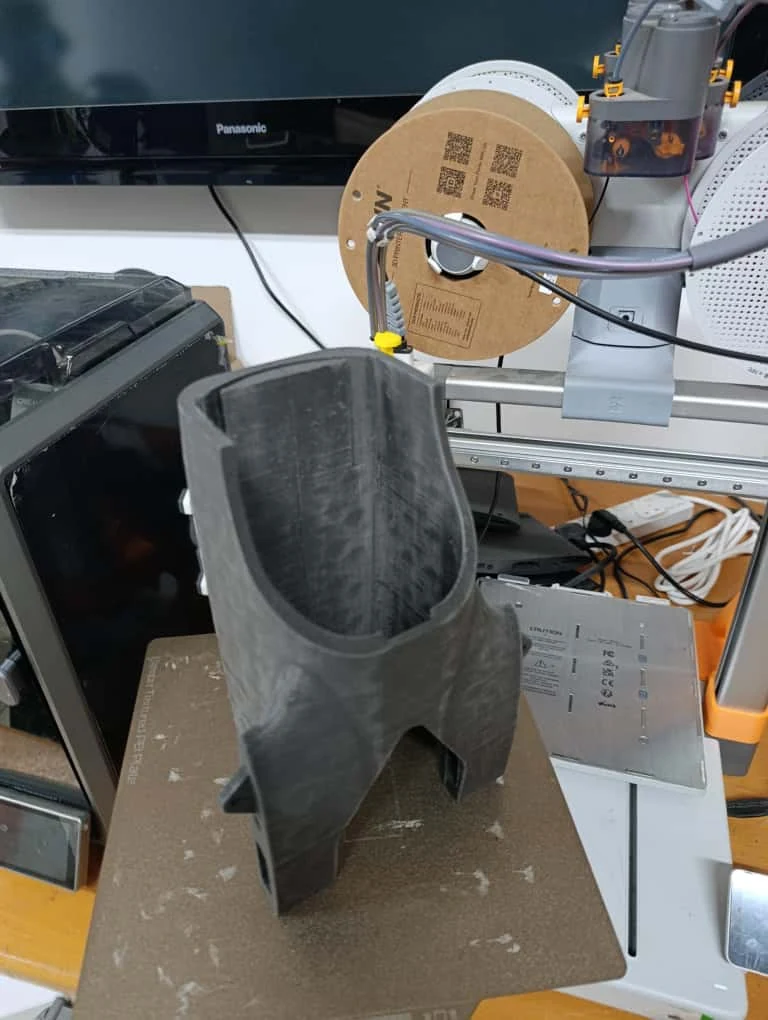 Close view of a large 3D-printed shell on a printer build plate